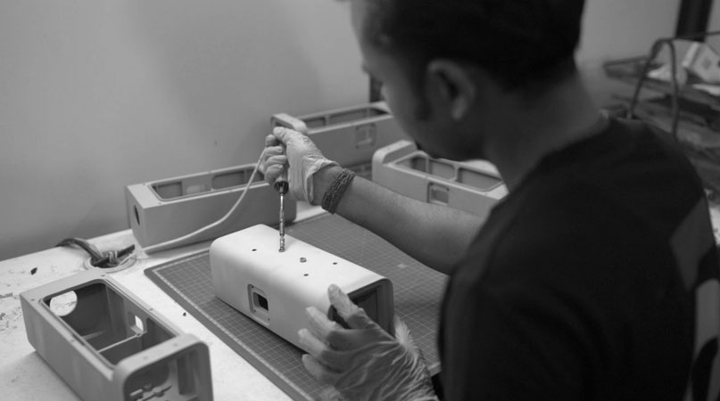 Cubein's technician working on a 3d printed prototype model with a tool